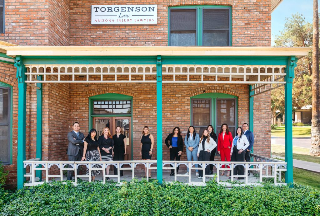 Torgenson law personal injury lawyers team in front of office.