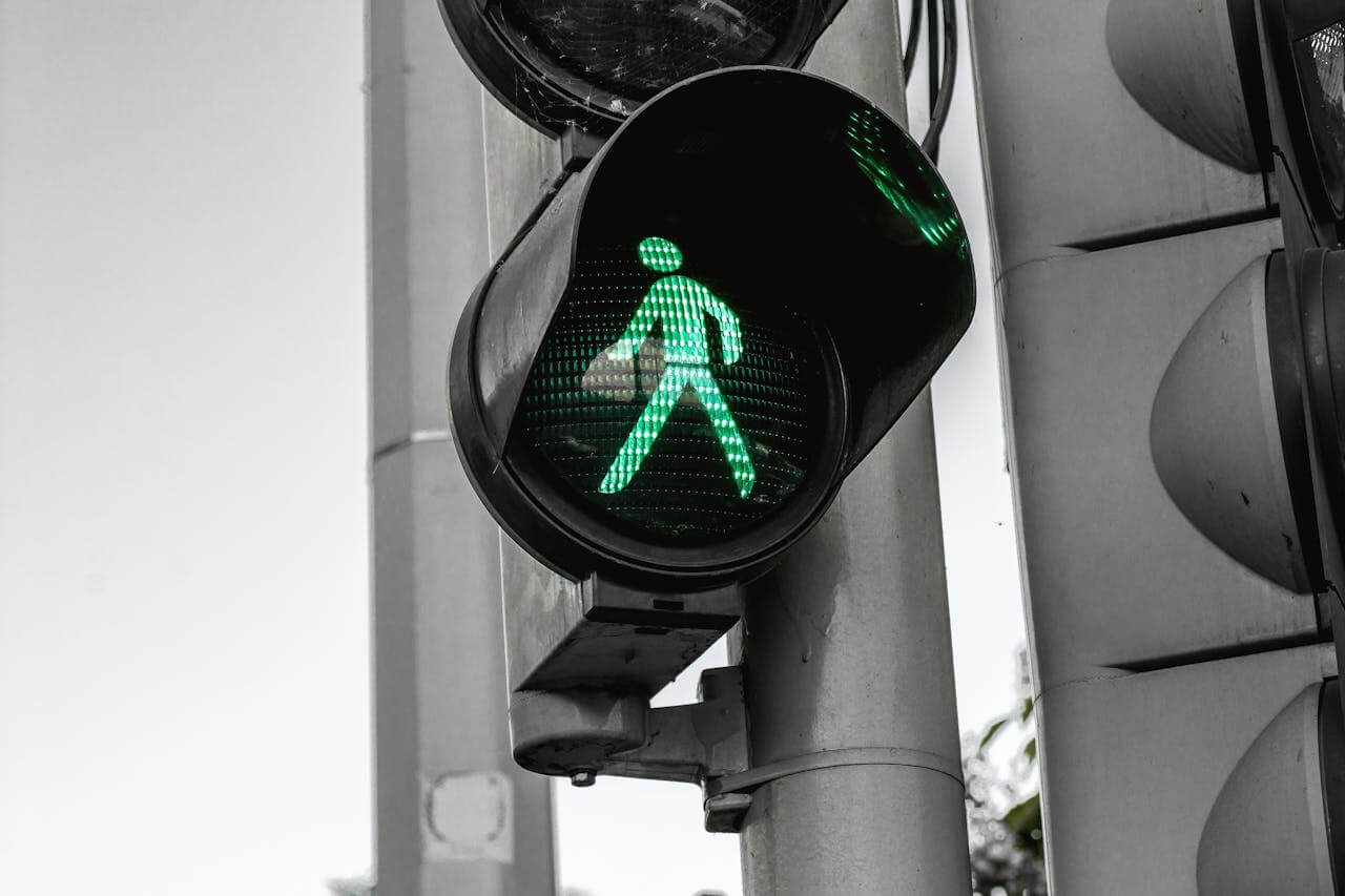 A pedestrian signal showing a green walking man.