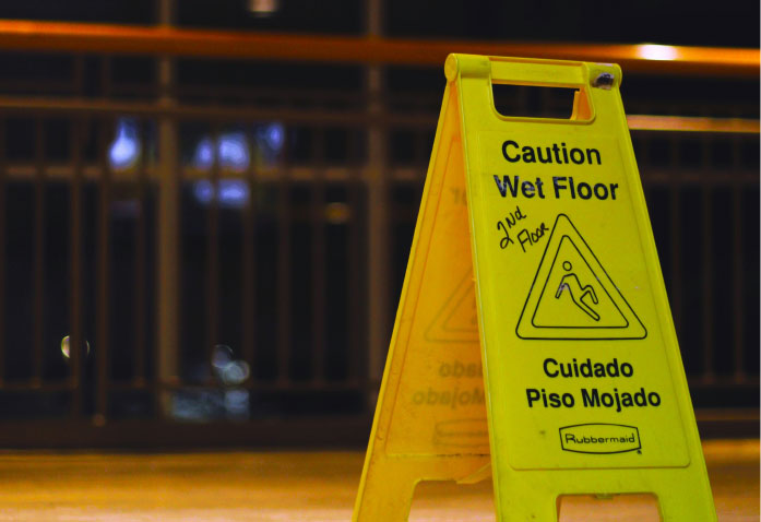 Yellow caution wet floor A-frame sign with 2nd floor handwritten on it, a common site for a personal injury claim.