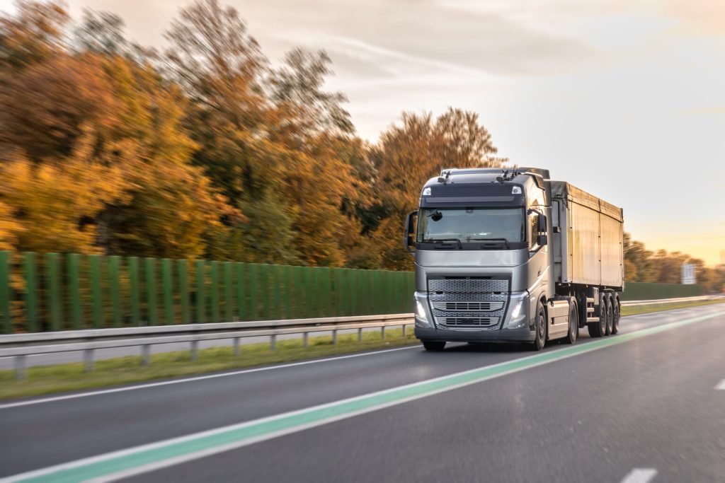 commercial truck driving on an open road.